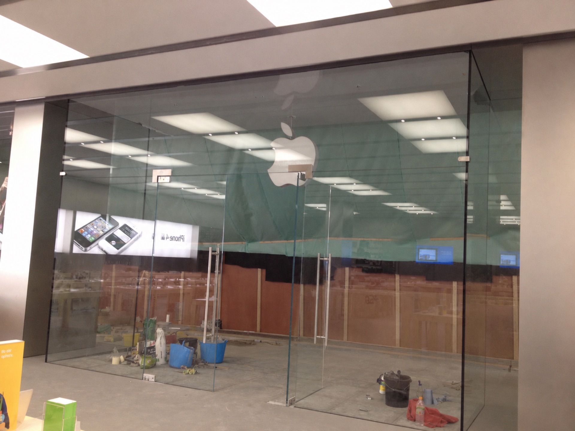 Frameless glass storefront glazed and protected during shopfit works at Watford