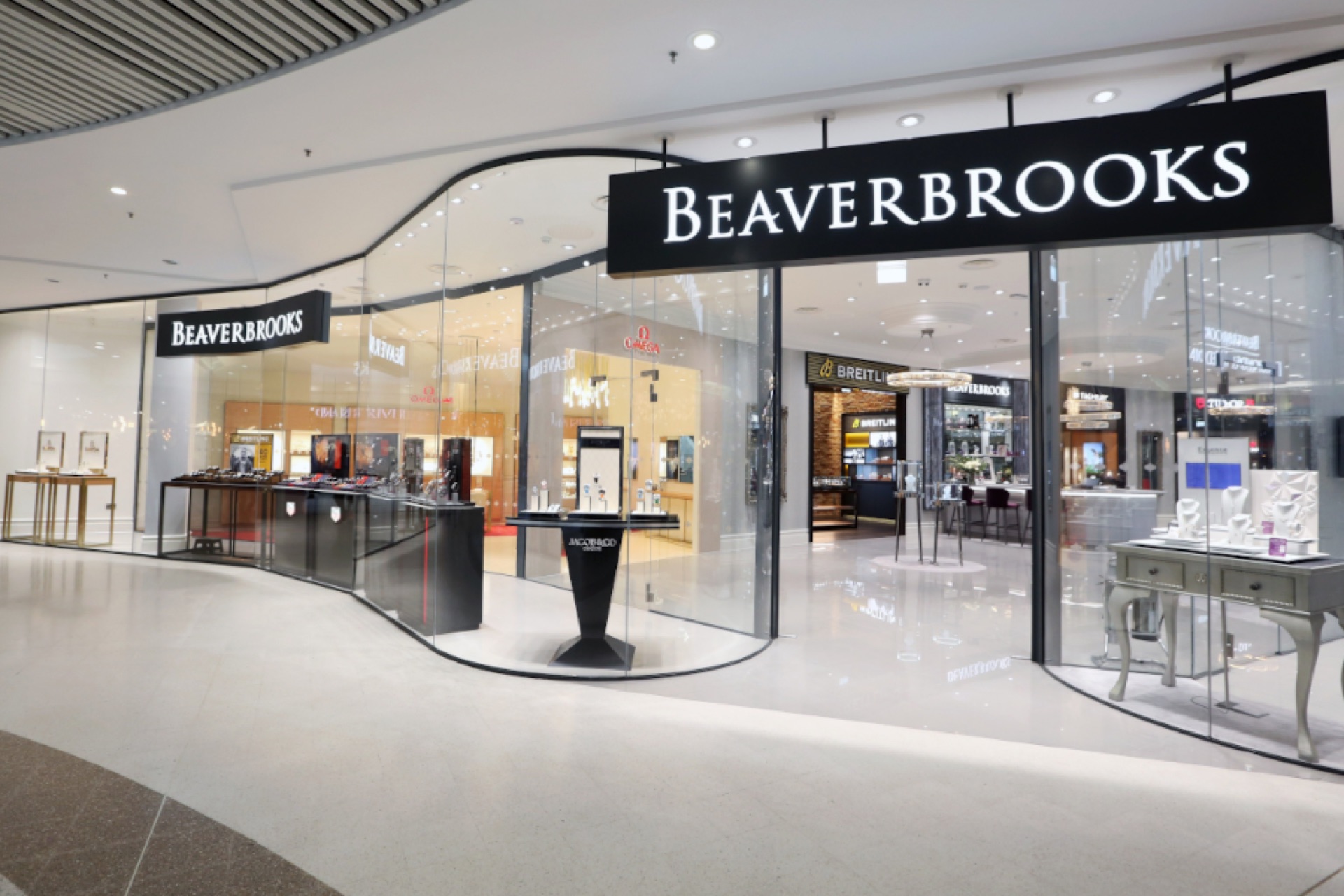 Finished curved glass storefront line at Beaverbrooks Braehead with displays in place
