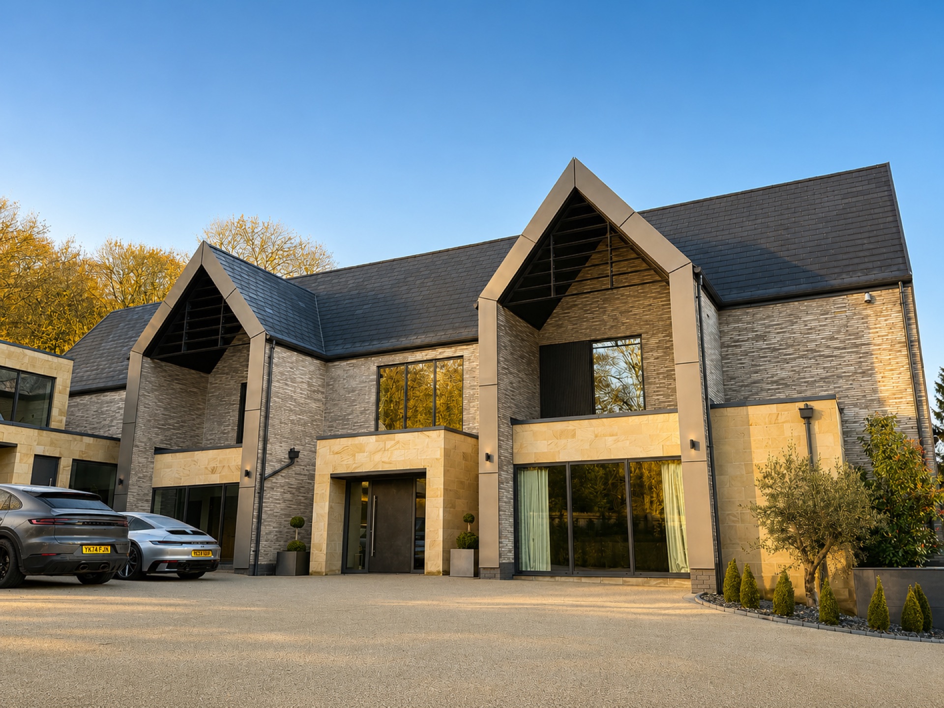 Front elevation of an Ilkley home with twin stone gables and dark aluminium windows