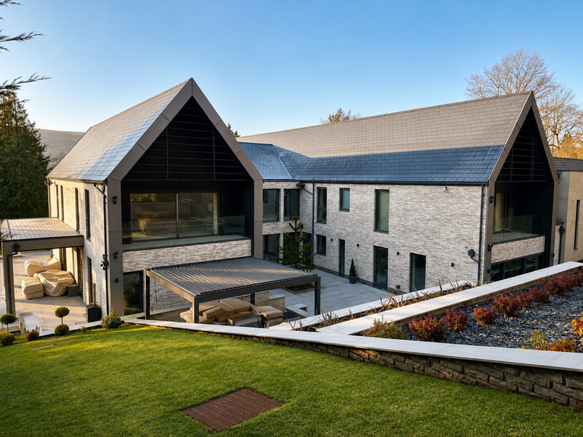 Rear elevation of an Ilkley new build showing large aluminium sliding doors and covered terrace