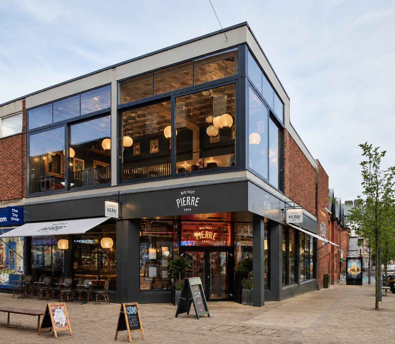 Two-storey aluminium curtain walling on a corner restaurant unit