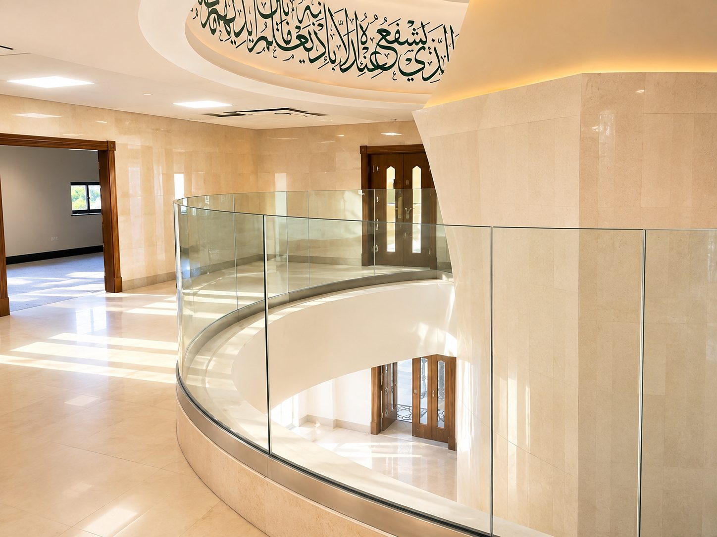 Curved frameless glass balustrade around a first-floor gallery