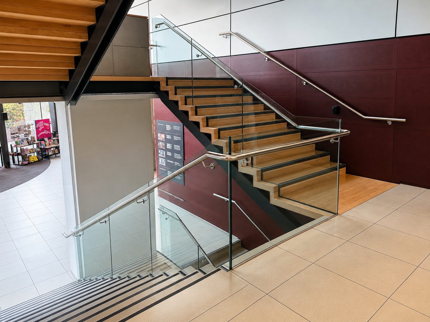 Glass balustrade with stainless steel handrail on a retail staircase