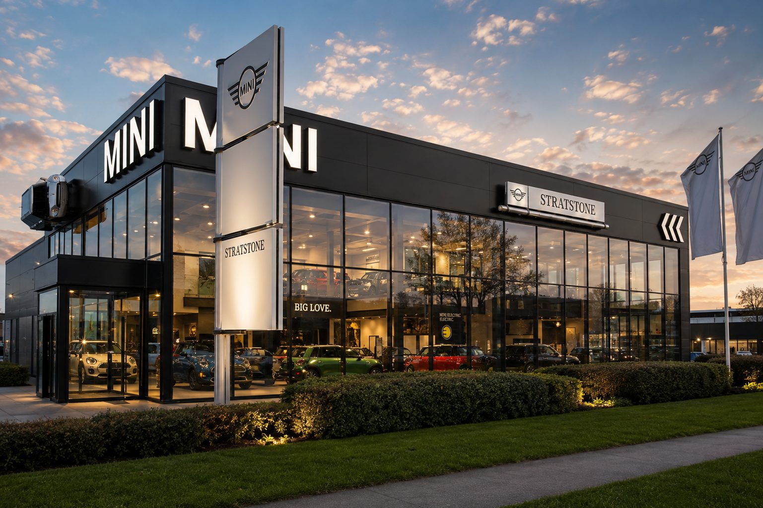 Aluminium curtain walling and glazed showroom frontage on a car dealership at dusk