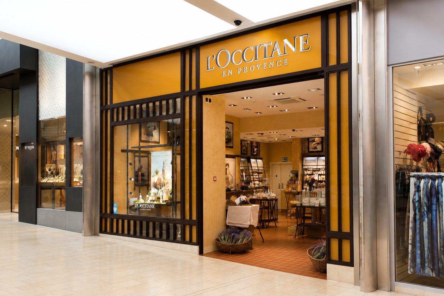 Retail shopfront with dark aluminium frames and timber fins in a shopping centre