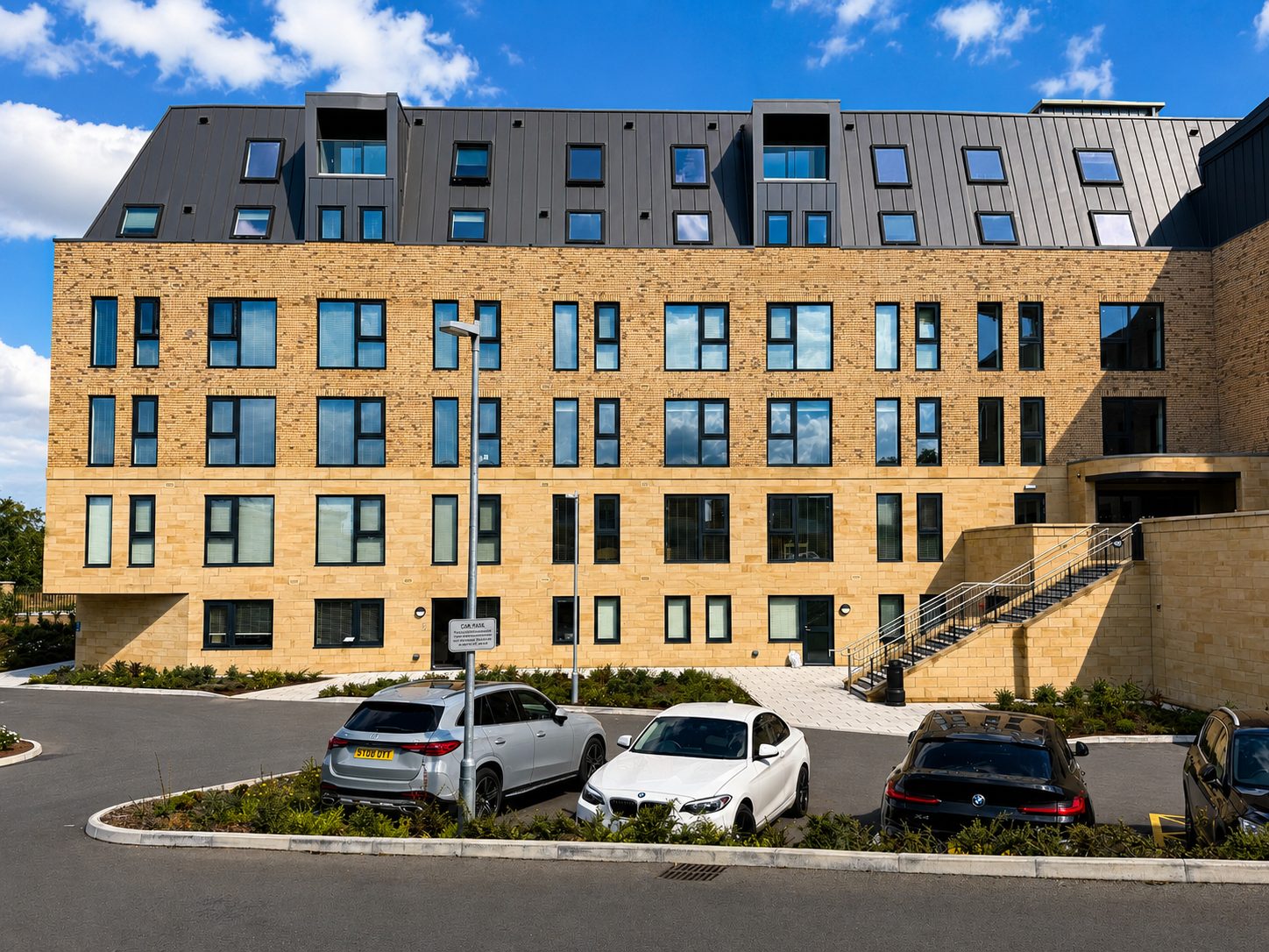 Front elevation of a brick apartment block with aluminium windows