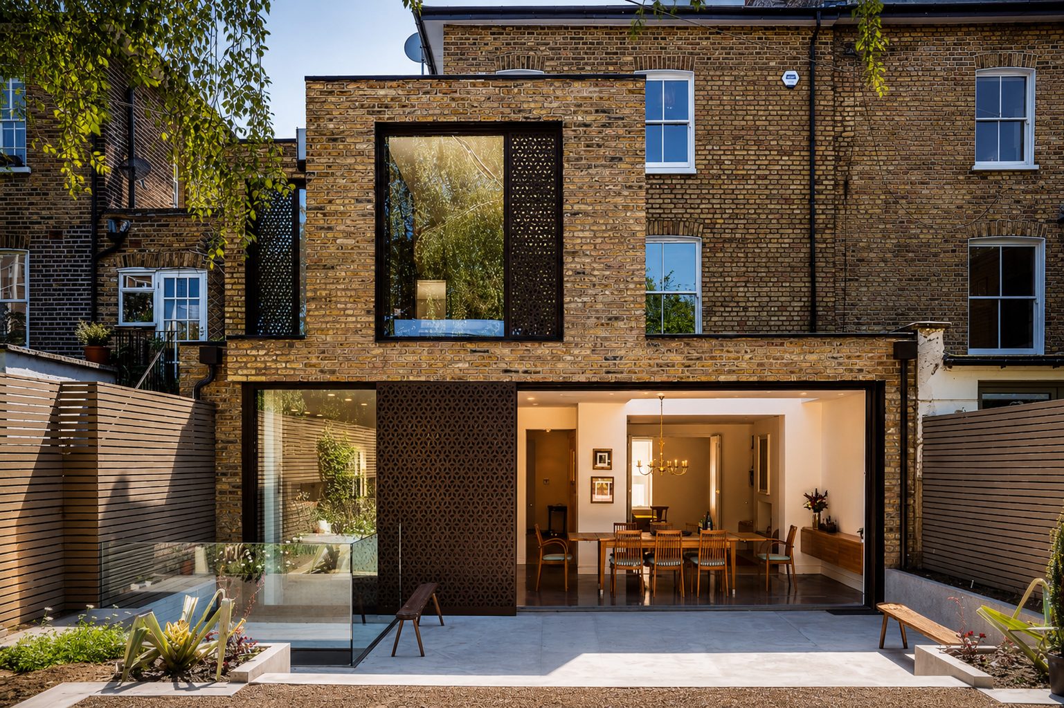 Rear extension on a brick terraced house with full-width sliding glass doors open to the garden