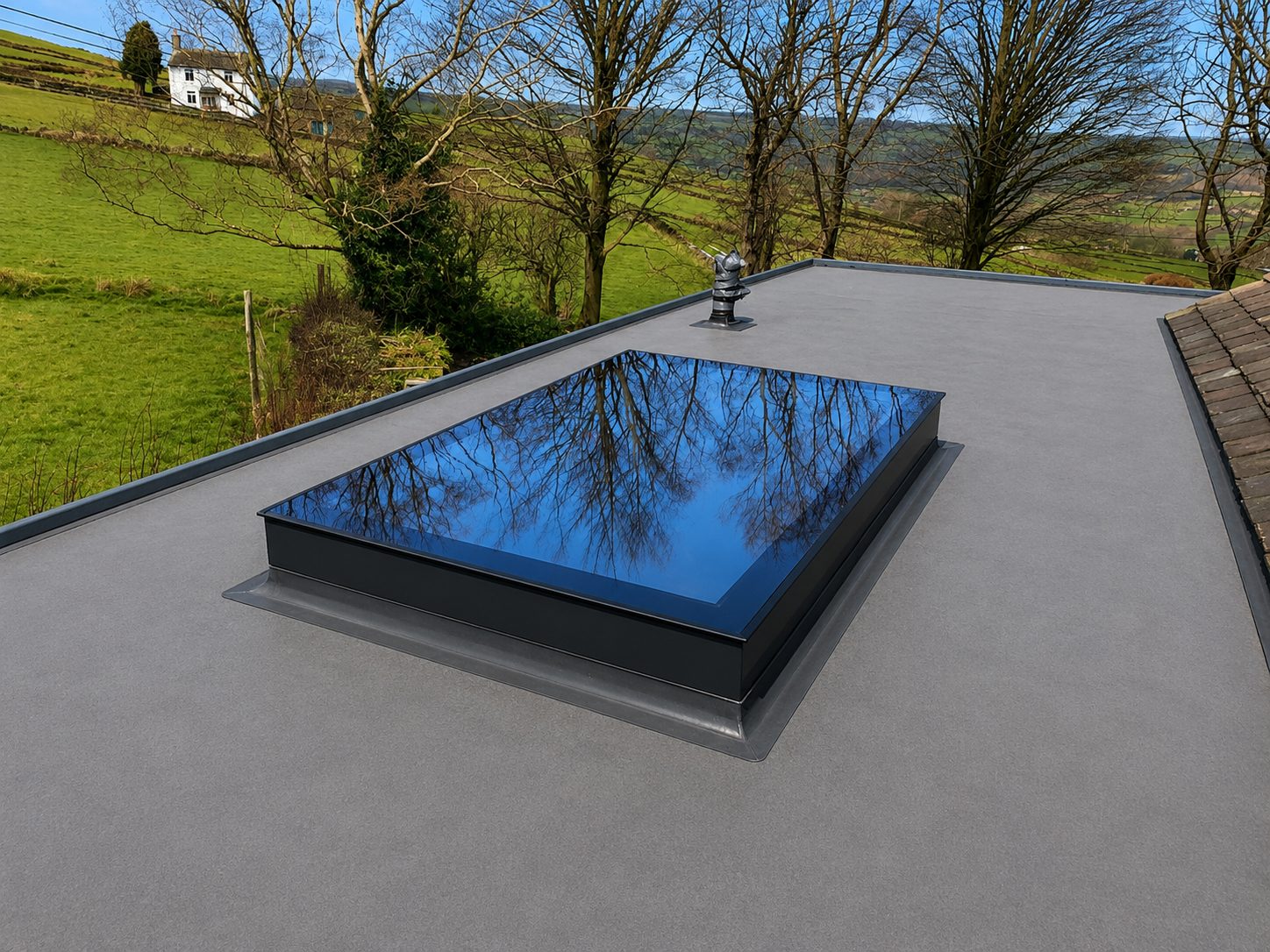 Frameless flat rooflight on a flat roof with countryside views